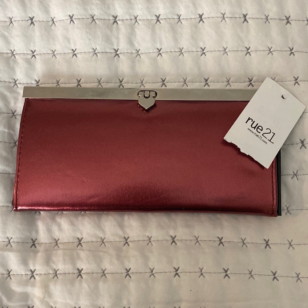 2 clutched. One metallic red -brand new with tag and other used black